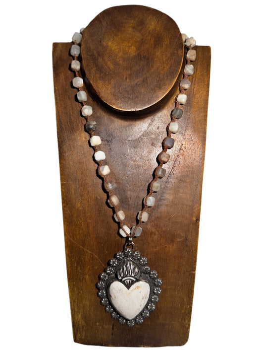 Necklace with heart pendant on a wooden stand