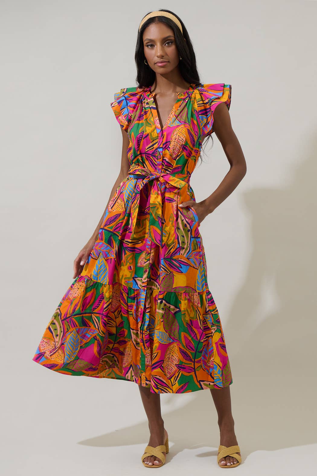 model in a midi length tropical print dress with a ruffled neckline and buttons at the center front