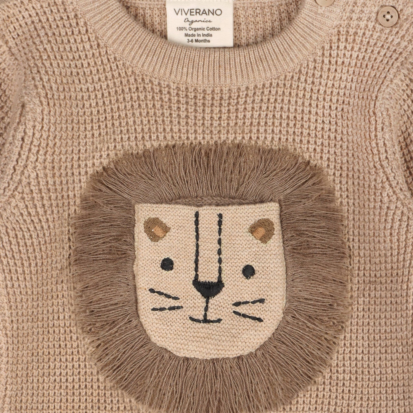 close up of lion 3D embroidery on light brown baby sweater 