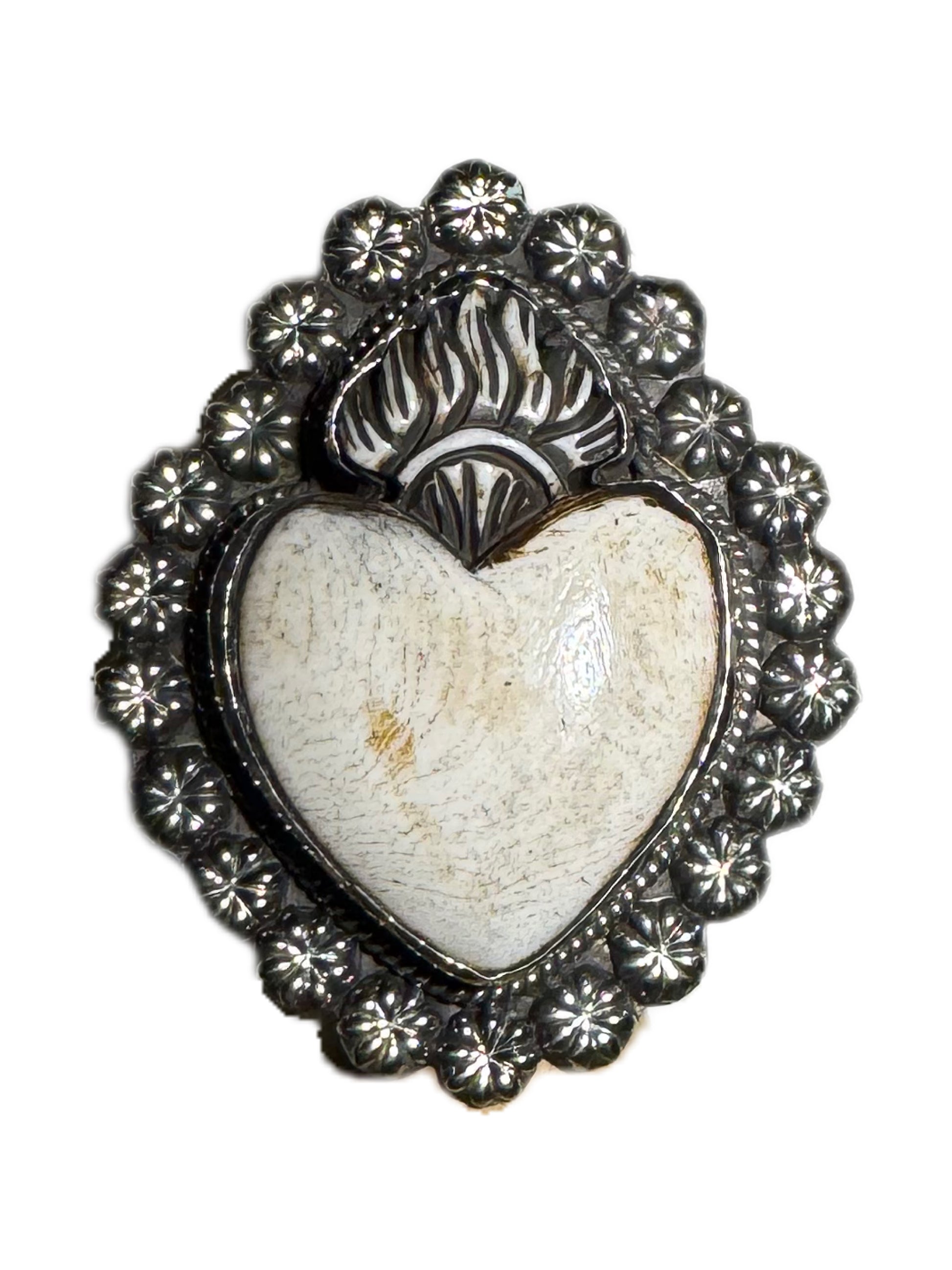 Heart-shaped stone with silver decorative frame on a white background