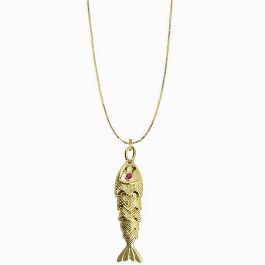 Gold fish-shaped pendant with a red gemstone on a white background