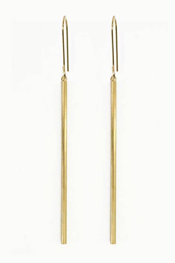 Gold rod earrings on a white background