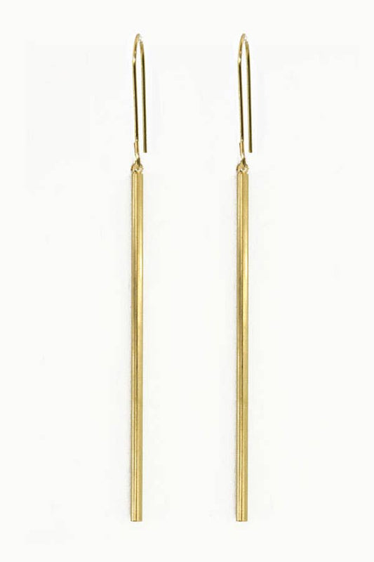 Gold rod earrings on a white background