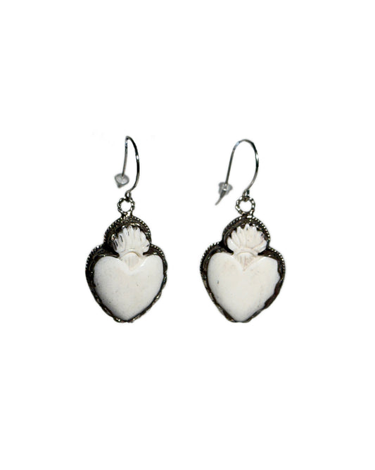 Heart-shaped earrings made of bone on a white background