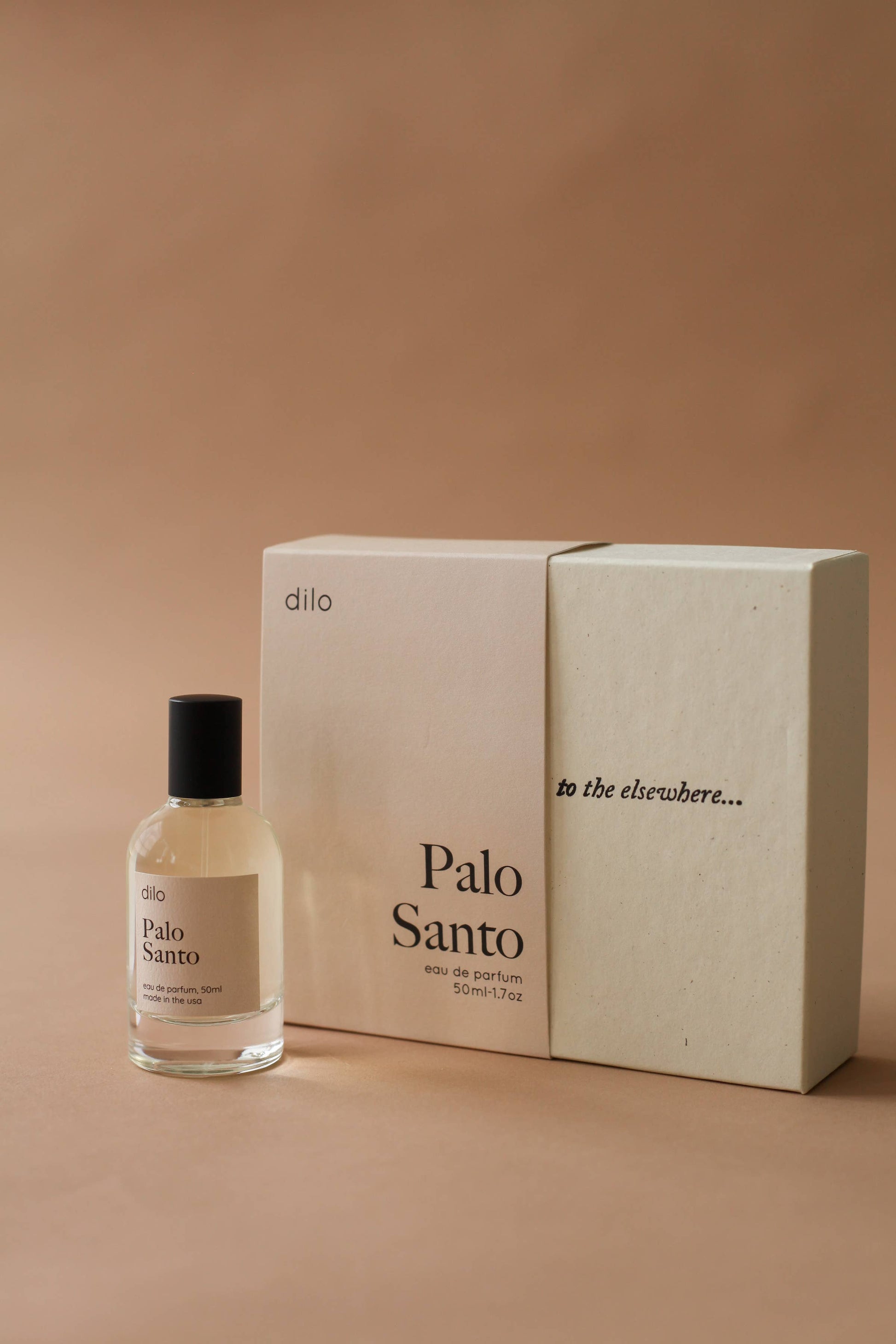 Palo Santo perfume bottle and packaging on a beige background