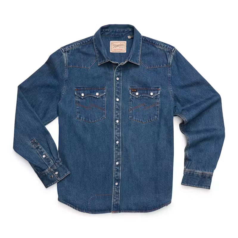 A blue denim long-sleeve button-up shirt with two chest pockets and pearl snaps, laid flat on a white background.