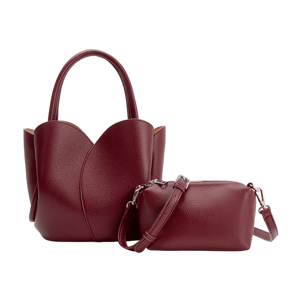 Two maroon handbags, one with a shoulder strap and the other with handles, on a white background.