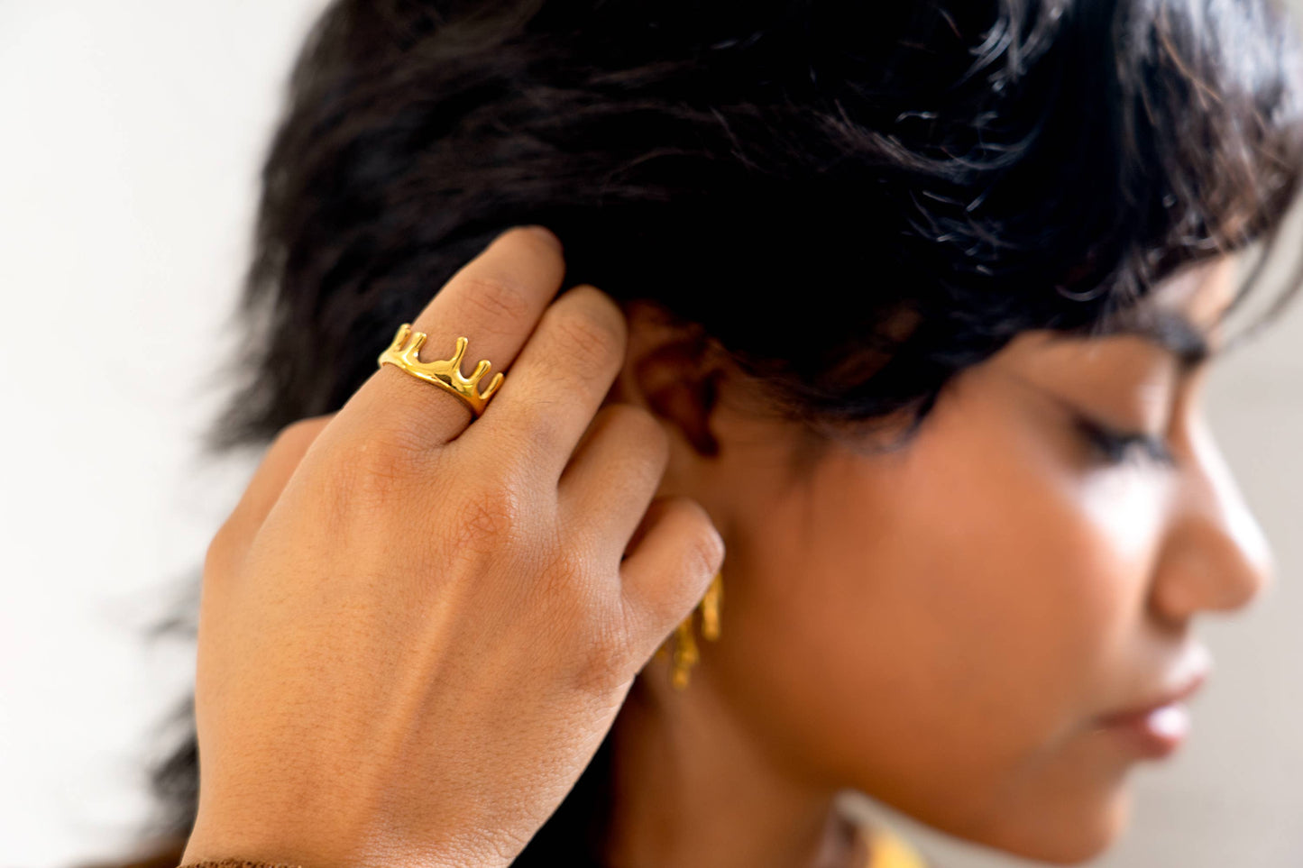 model is wearing a dripping gold ring