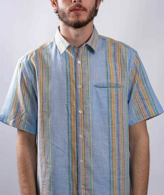 model wearing blue and colorful striped linen button up collared short sleeve shirt