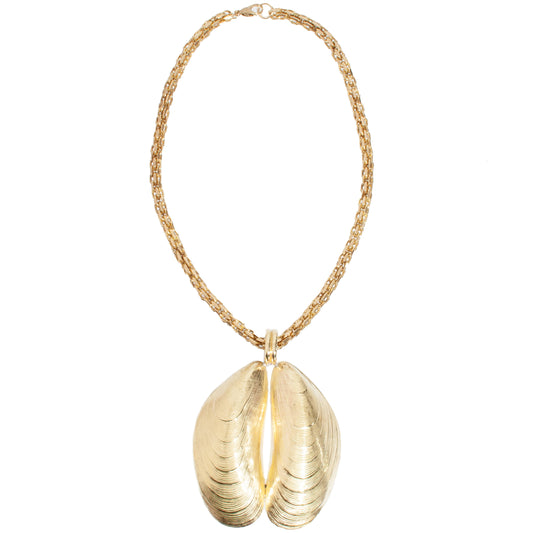 A gold-tone necklace featuring a thick braided chain and a large pendant shaped like an open clam shell, shown against a plain white background.