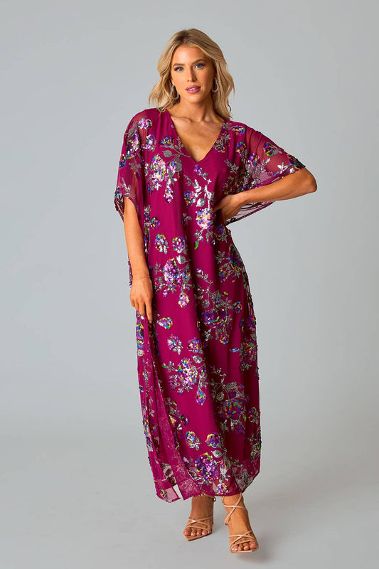 model wearing red sangria colored short sleeve v-neck maxi dress with colorful sequin pattern