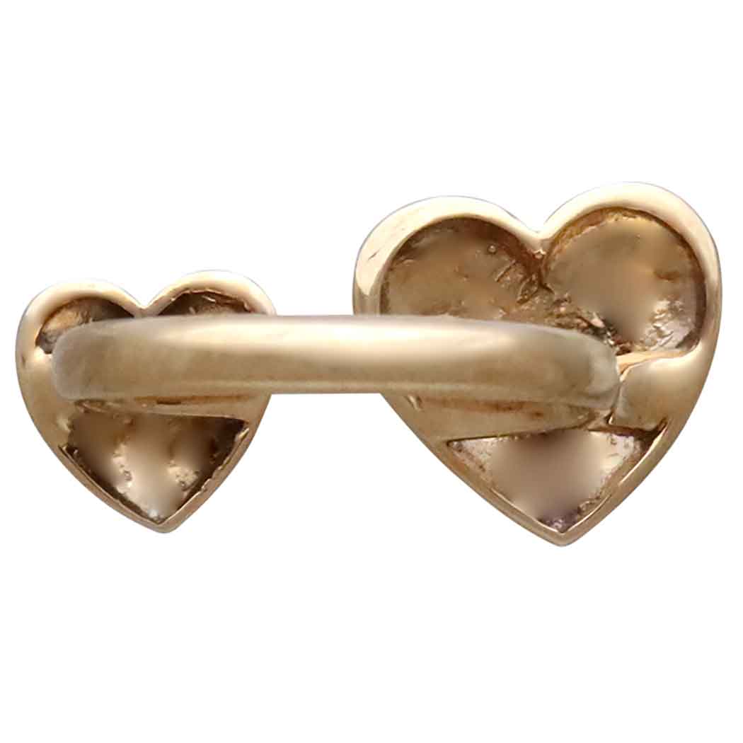 back view of Gold heart-shaped key on a white background