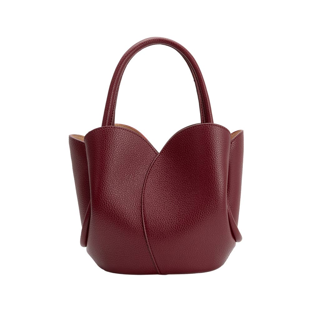 Red handbag with a textured surface on a white background