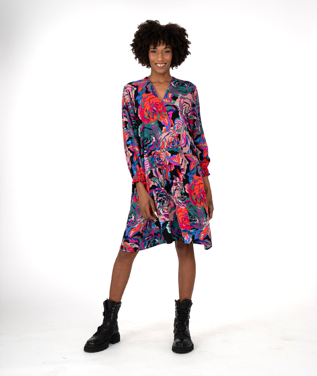 model in a floral print A-line shape dress has a plunging v-neck, gathers at the waist, elastic in the cuffs