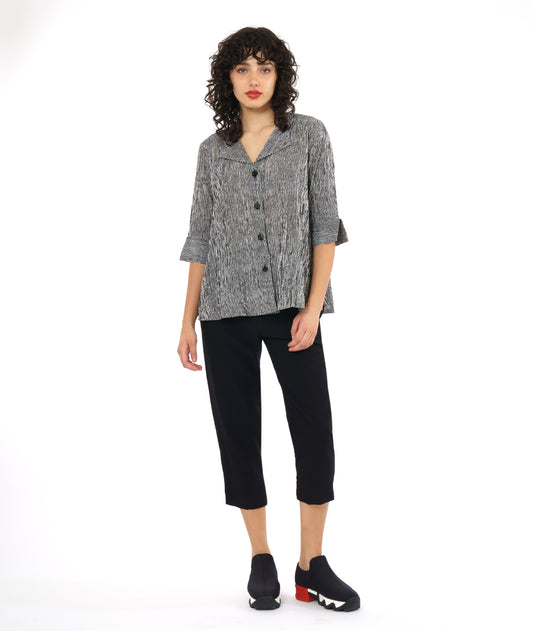 model in a slim black crop pant, with a black and white striped button down blouse. blouse has 3/4 sleeves and a flat collar