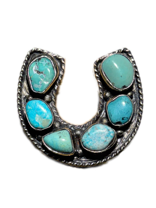 Horseshoe-shaped jewelry with turquoise stones on a white background