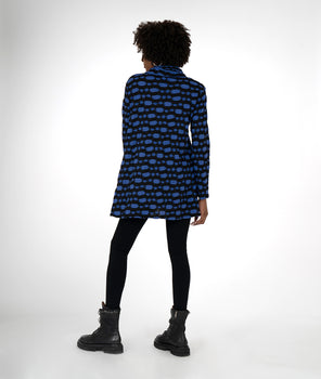 model in a black legging with a black and blue striped tunic with a cowl neck and princess seams