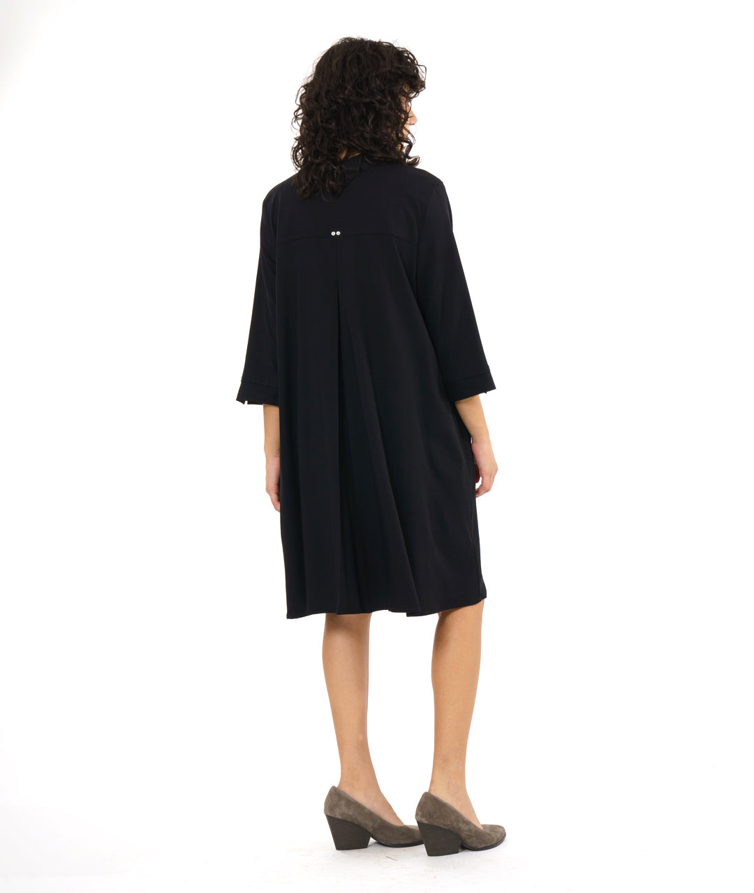 model in a black, knee length button down shirt dress with 3/4 sleeves and a twin button detail