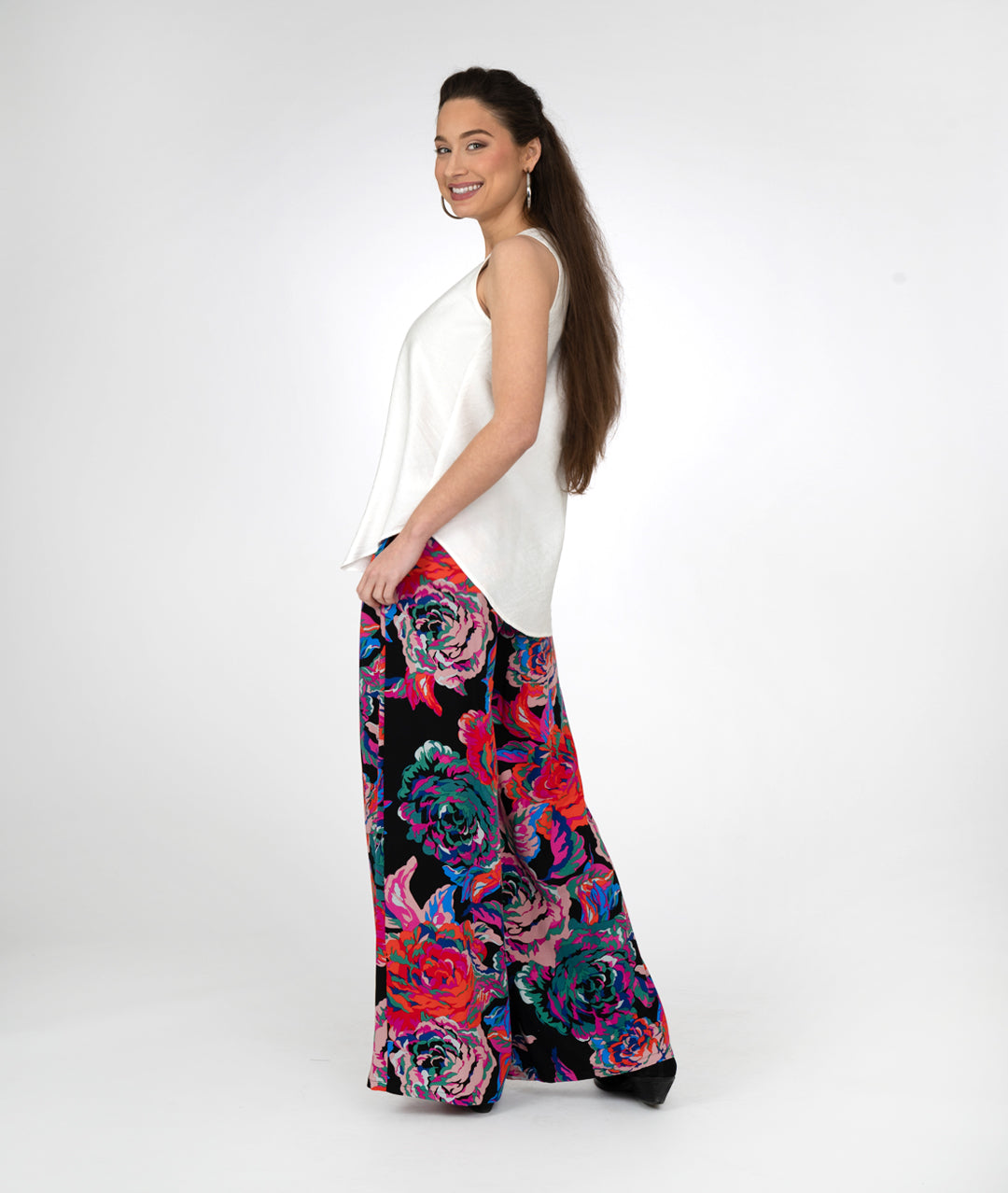 model in a white tanktop with a black and floral print palazzo pant