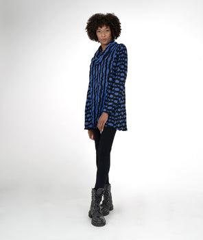 model in a black legging with a black and blue striped tunic with a cowl neck and princess seams