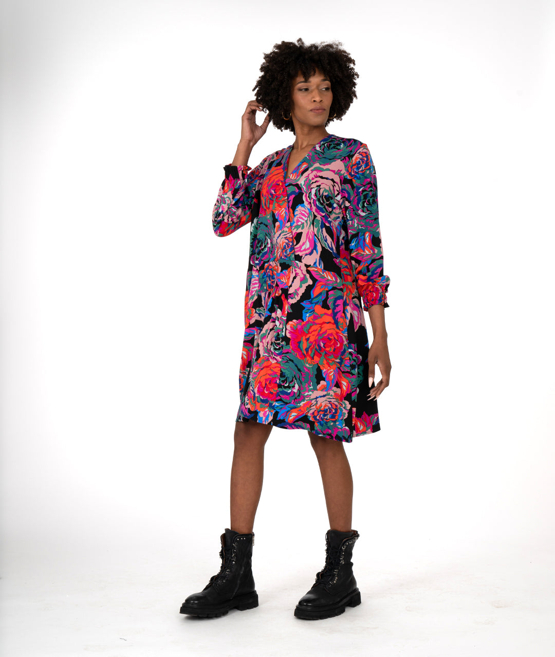 model in a floral print A-line shape dress has a plunging v-neck, gathers at the waist, elastic in the cuffs