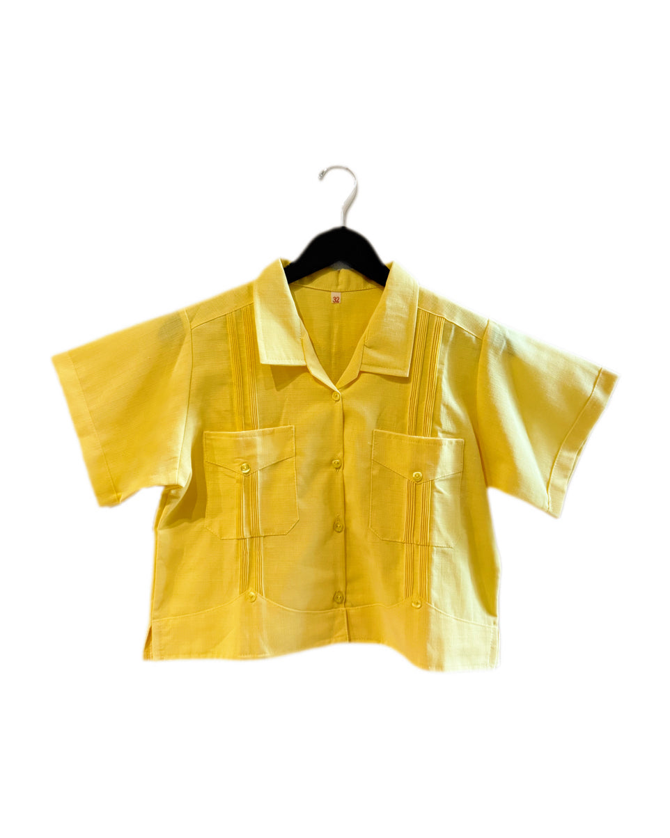 Yellow shirt on a hanger against a white background