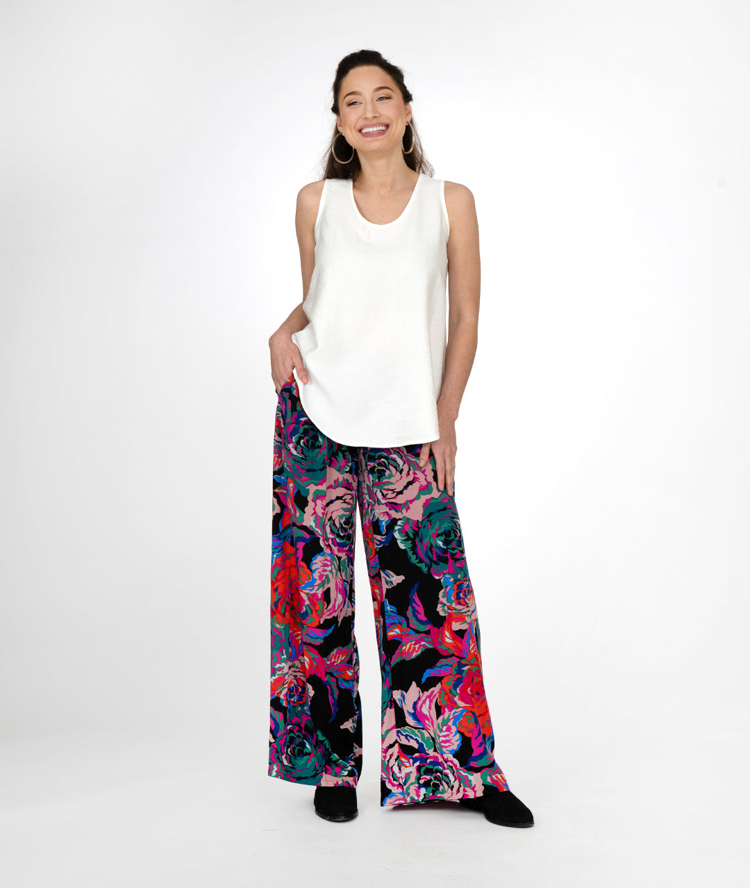 model in a white tanktop with a black and floral print palazzo pant