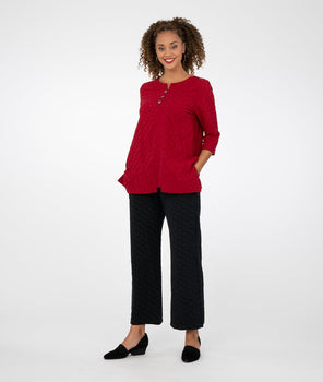 model is wearing a red top with black pants and black shoes