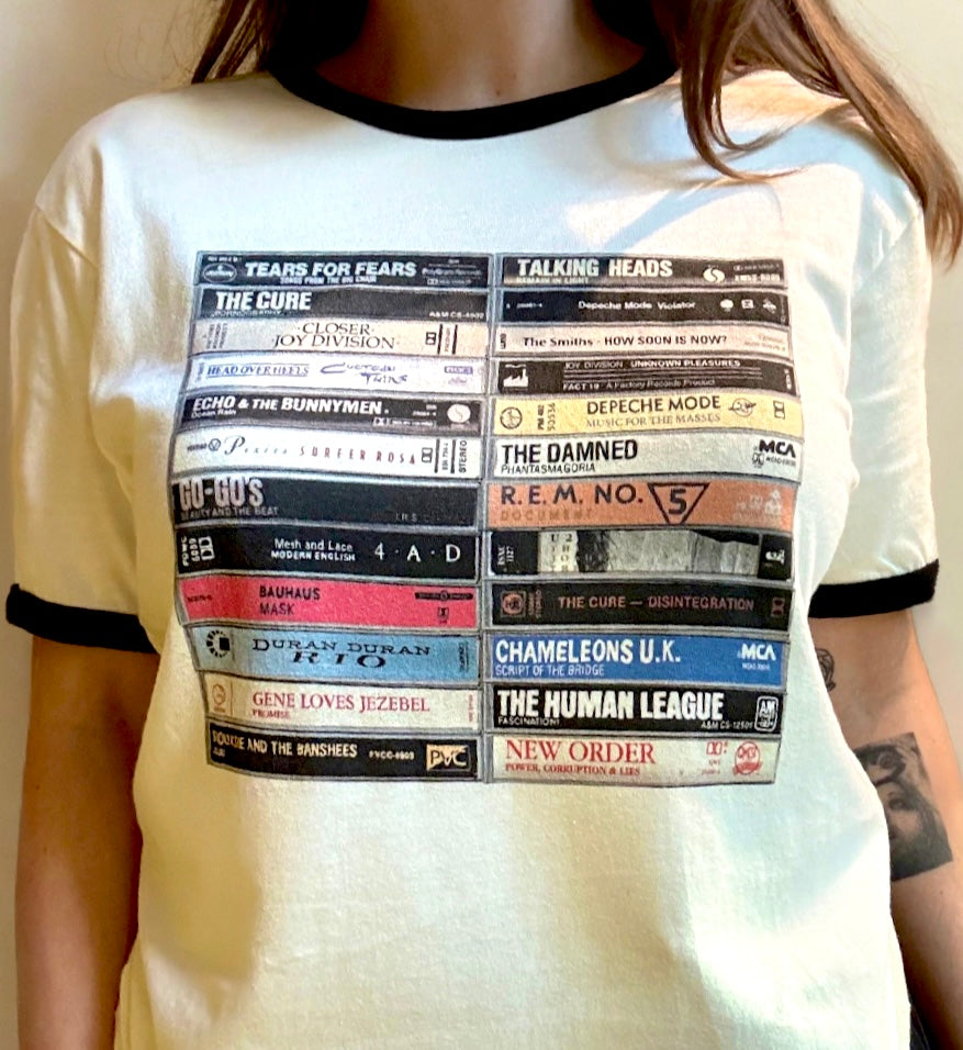 T-shirt with cassette tape design featuring album names on a plain background