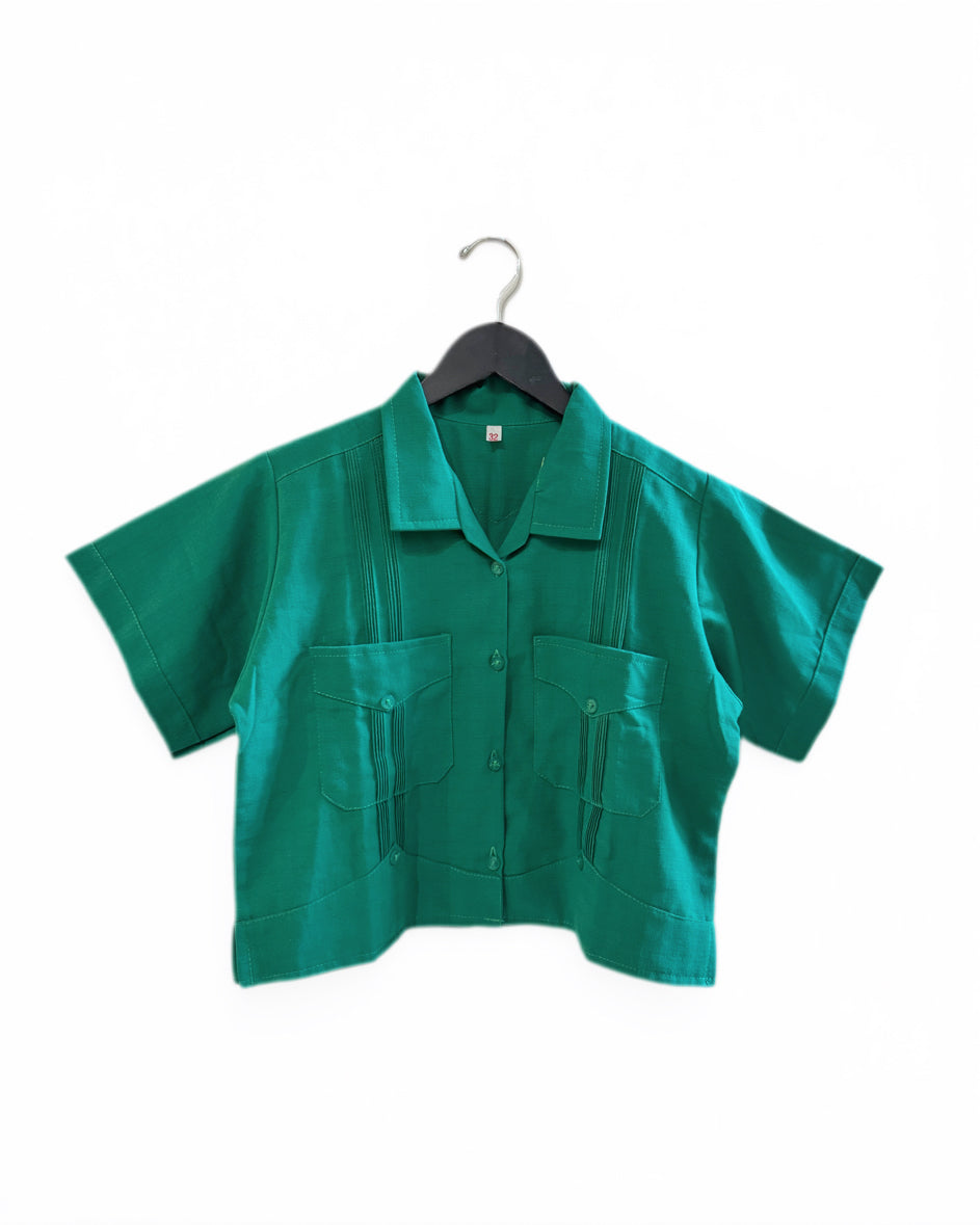 Green shirt on a hanger against a white background