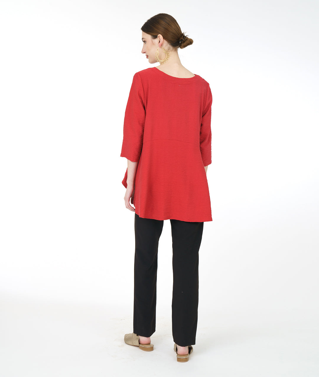 model in a slim black pant with a red pullover top with 3/4 sleeves and a swingy back