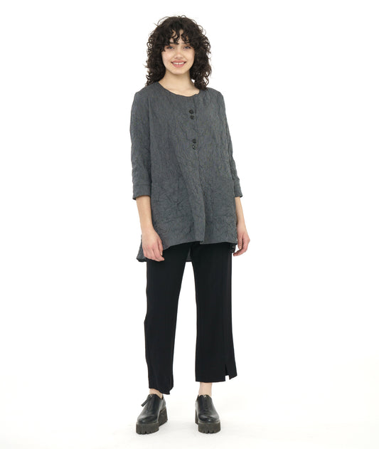 model in a straight leg black pant with a black and grey pinstriped pullover top with a long body, 3/4 sleeves, squared hip pockets and two sets of double buttons at the front placket beneath a rounded neckline