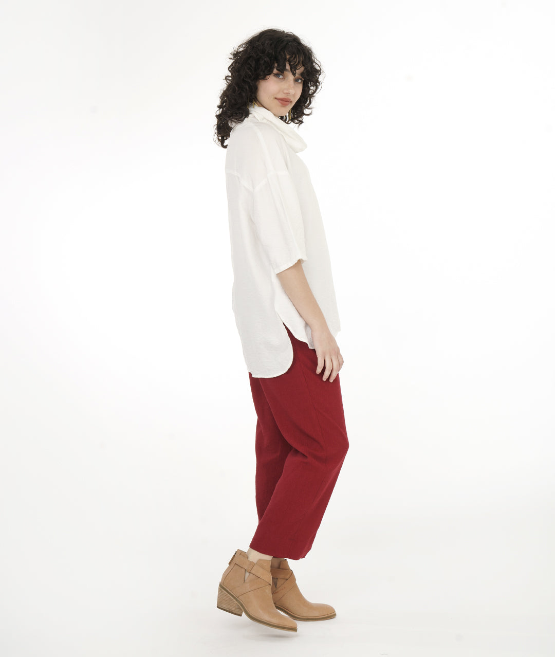 model in a straight leg red pant with a boxy cowl neck top