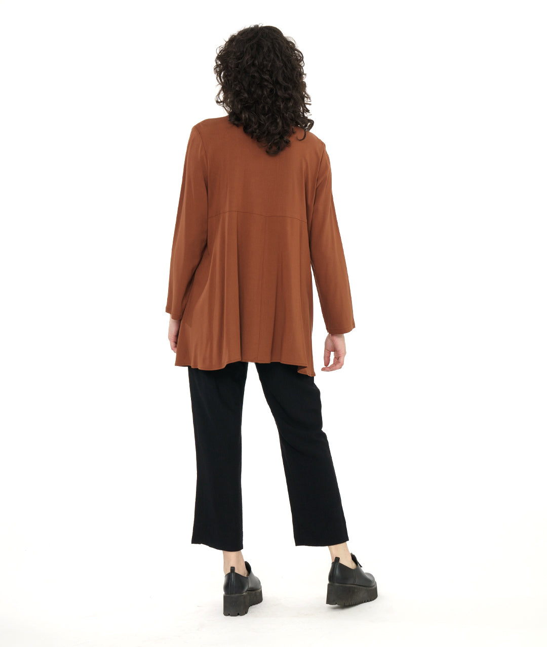 model in a straight leg black pant with a rust color button down blouse with a gathered detail at each front hip