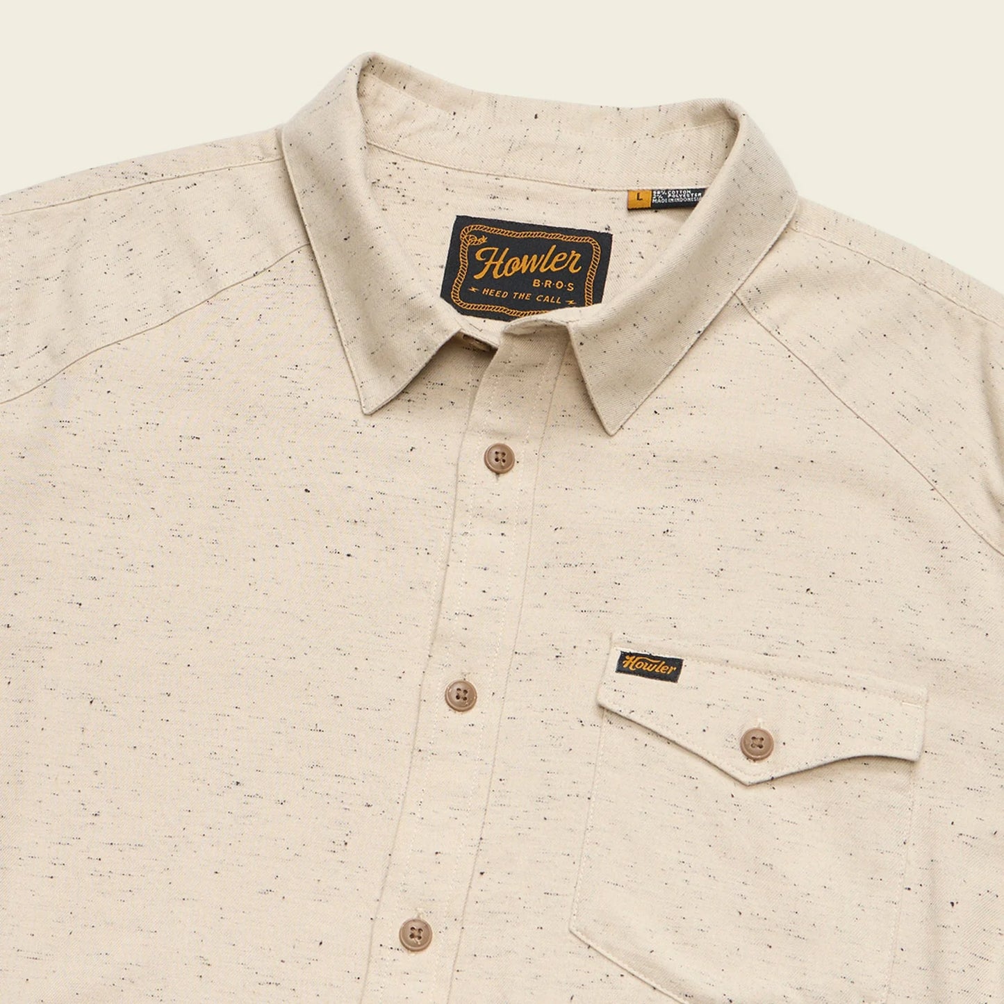 Beige patterned shirt with Howler brand label on a beige background