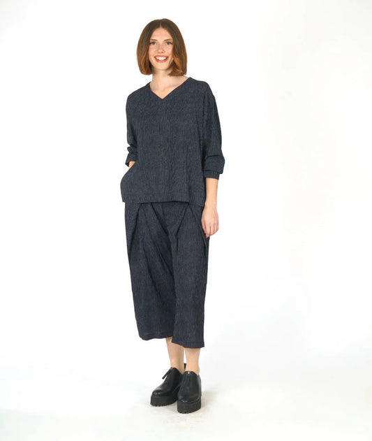 Woman wearing a dark grey outfit on a white background