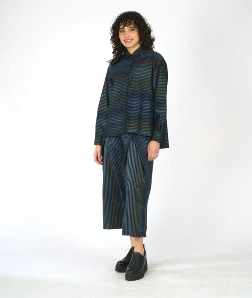 model wearing matching striped button up long sleeve top and front pleated pant on white background