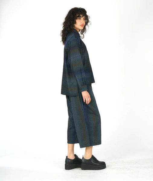 model wearing matching striped top and pant on white background