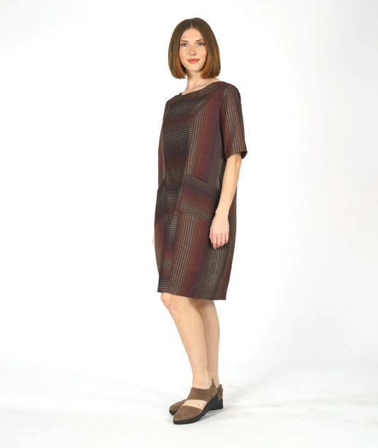 model wearing a striped half sleeve dress with two front pockets on a white background