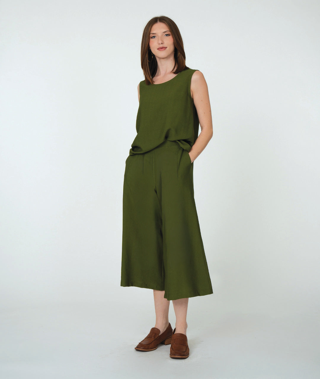 model in a pine green wide leg pant with a pleated flat front, worn with a matching sleeveless top