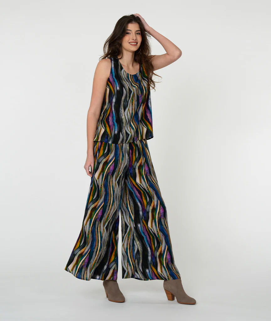 Model wearing 'watercolor' pattern tank top and pants with white background.