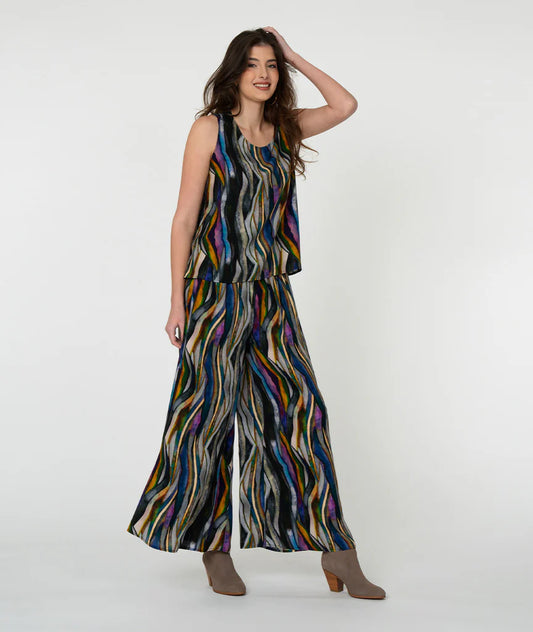 Model wearing 'watercolor' pattern tank top and pants with white background.