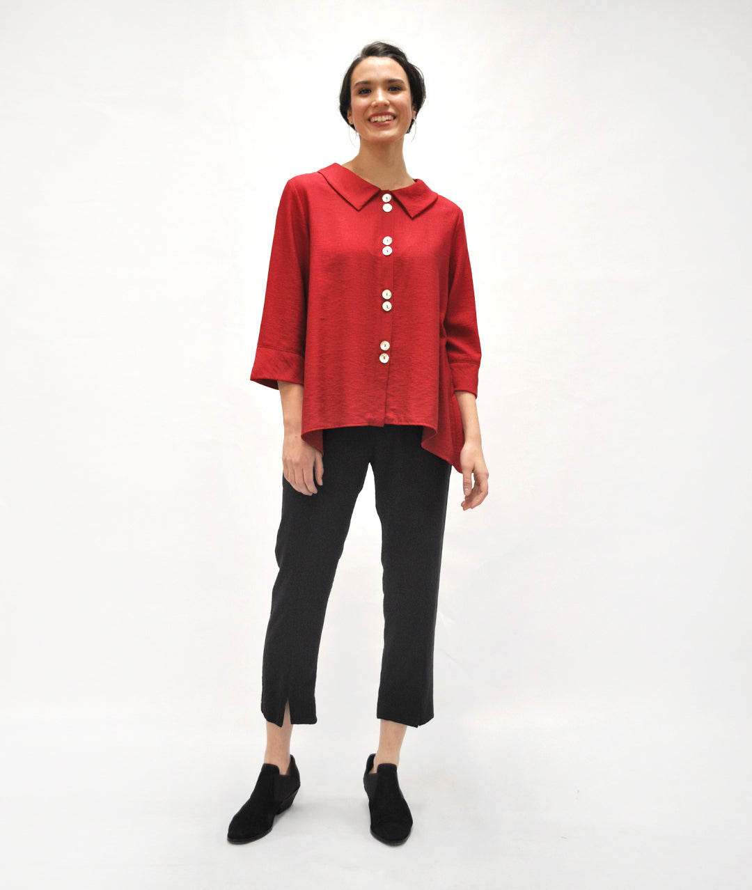 model in a slim black pant with a button up cranberry red blouse