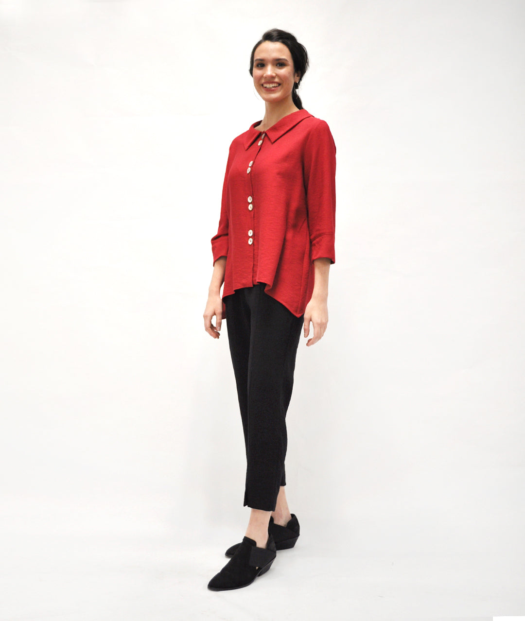 model in a slim black pant with a button up cranberry red blouse