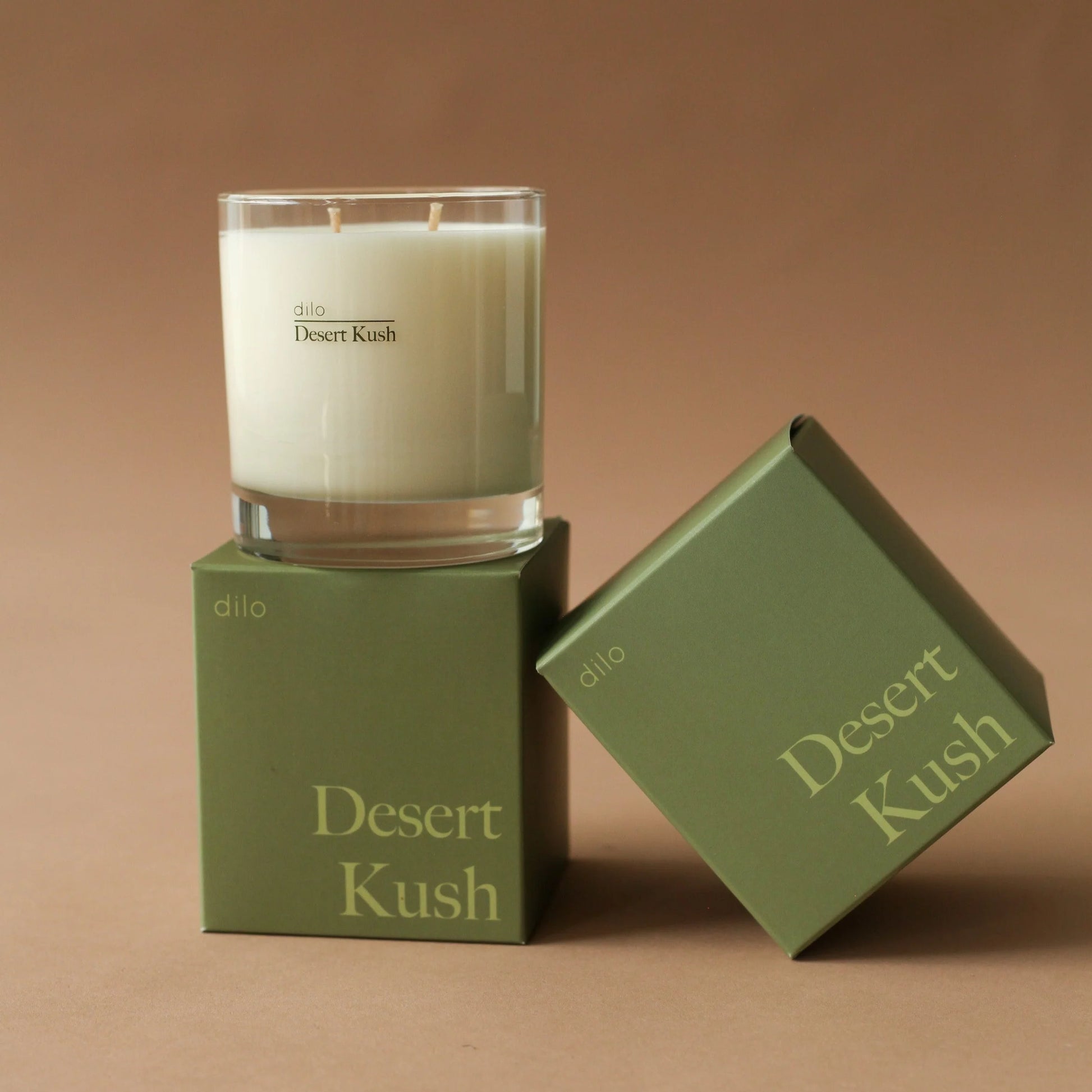 desert kush scented candle with 2 of the packaging