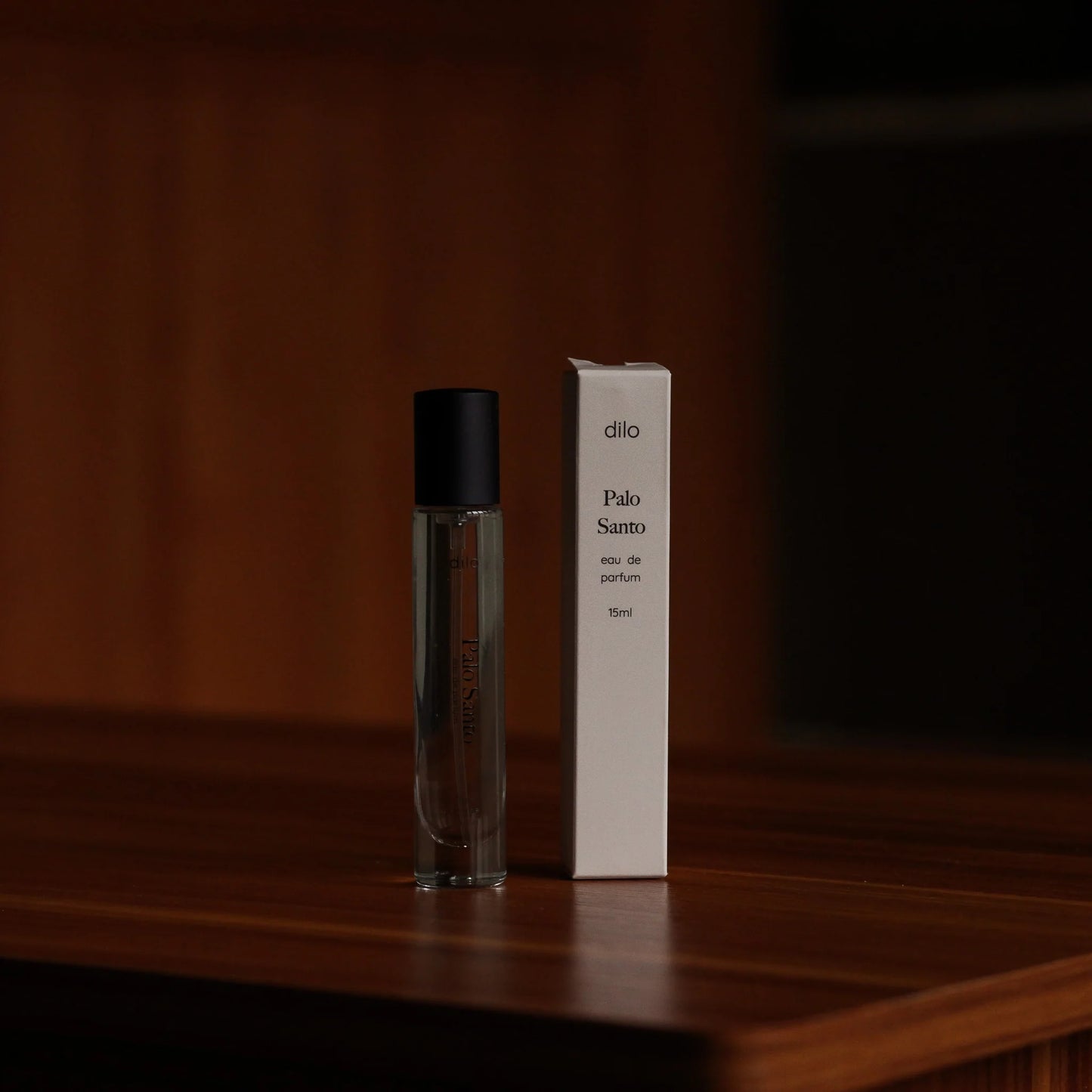 palo santo scented perfume bottle with packaging on wood table