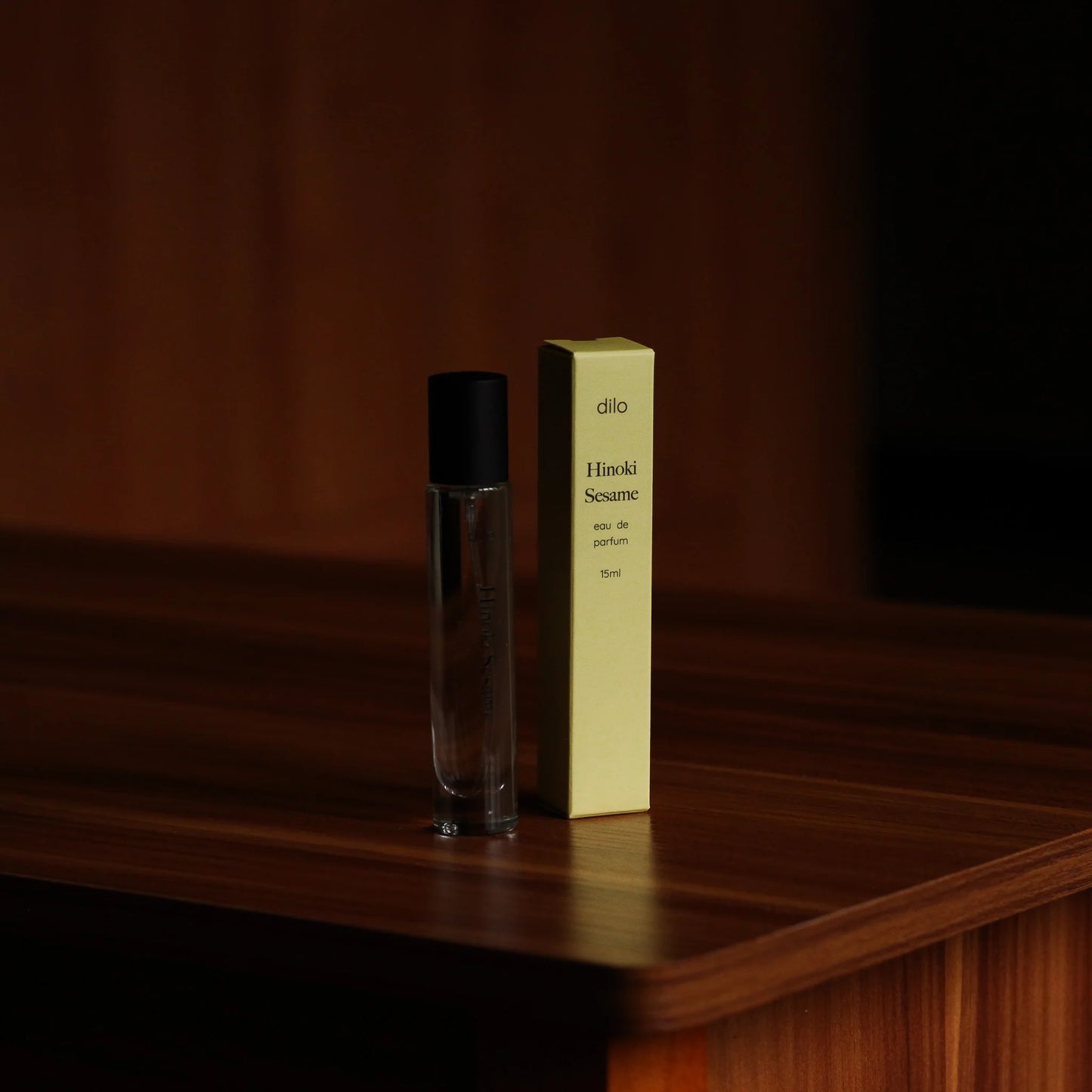 hinoki sesame scented perfume bottle with packaging on wood table