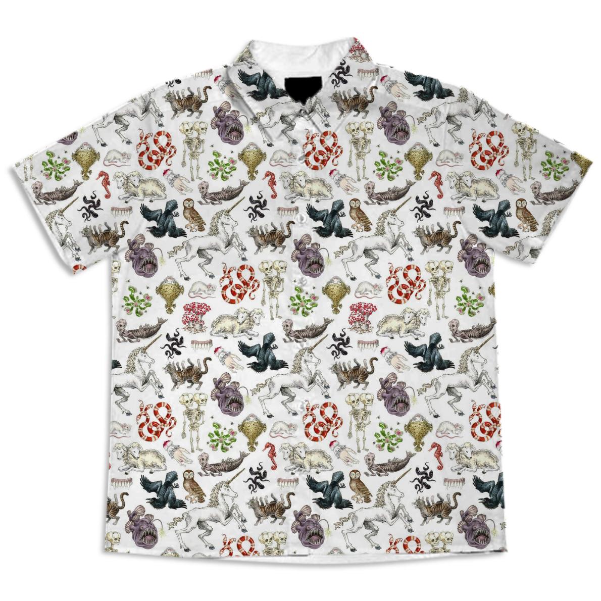 white linen button up shirt with various mythical/ oddity creatures on it such as a unicorn, pufferfish, owl, raven, three-headed snake, Venus fly trap, and two-headed lamb 