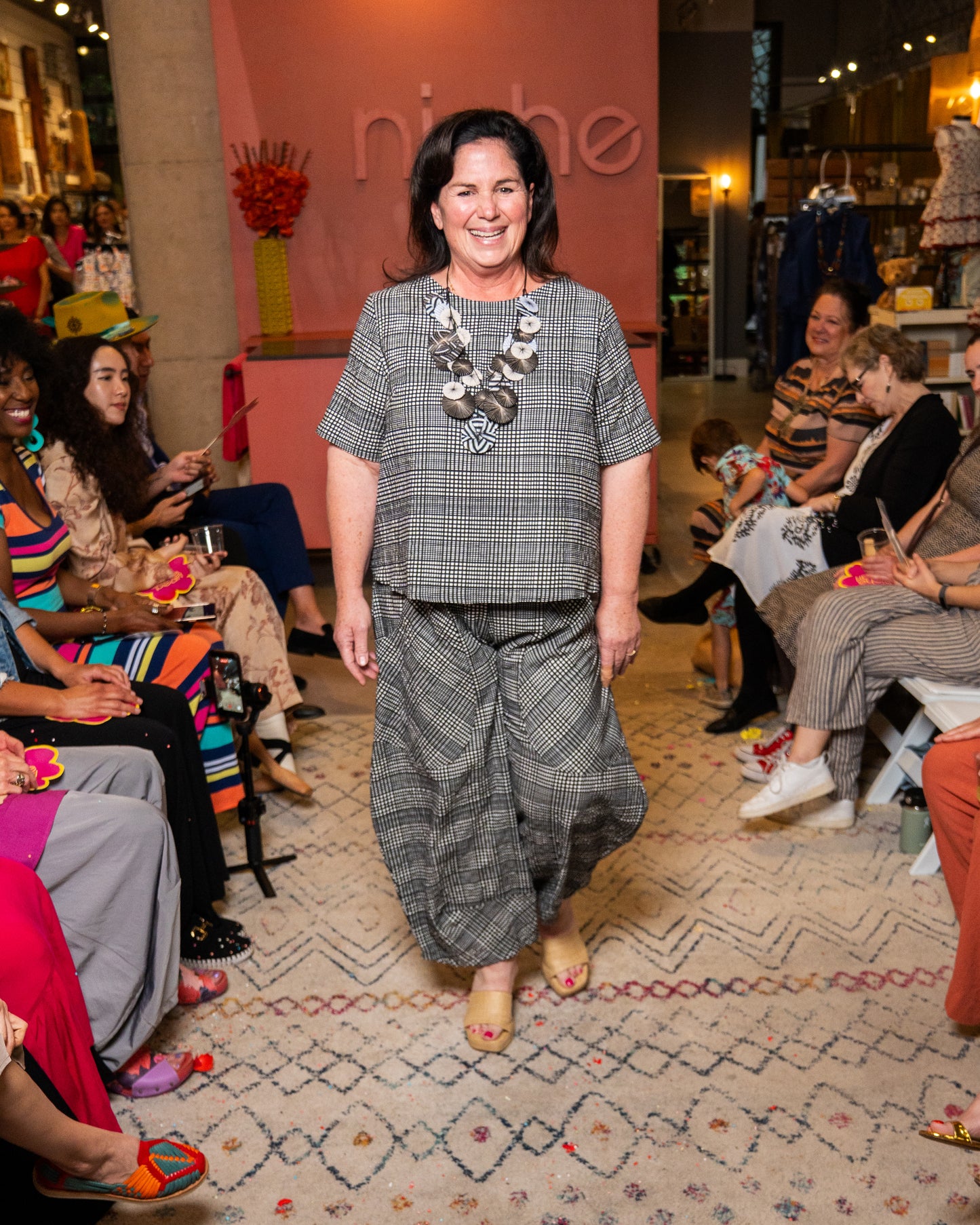 Woman in a checkered outfit at a fashion event