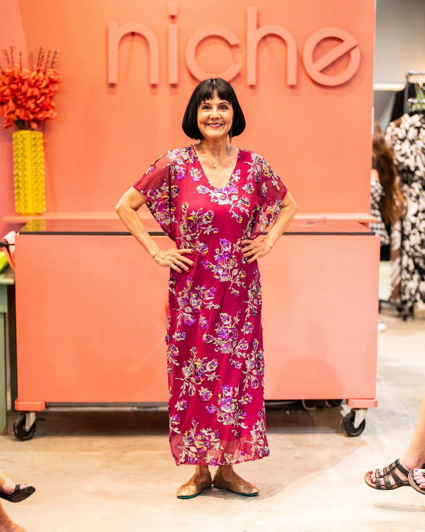 model wearing red sangria colored short sleeve v-neck maxi dress with colorful sequin pattern